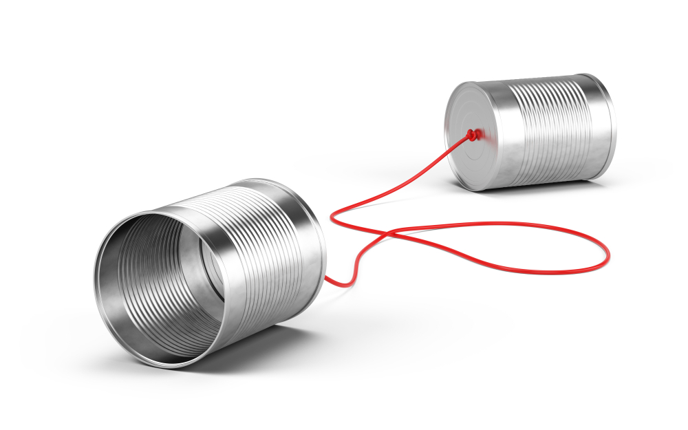 Two tin cans connected by a red string lie on a neutral background, symbolizing communication between two parties.