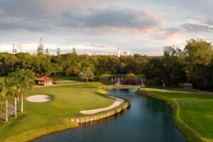 Aerial view of the Biltmore Golf Course’s 17th green, sand bunkers, waterway, bridge and surrounding trees.