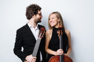 Cellist Laura Metcalf and guitarist Rupert Boyd pose together with their instruments.