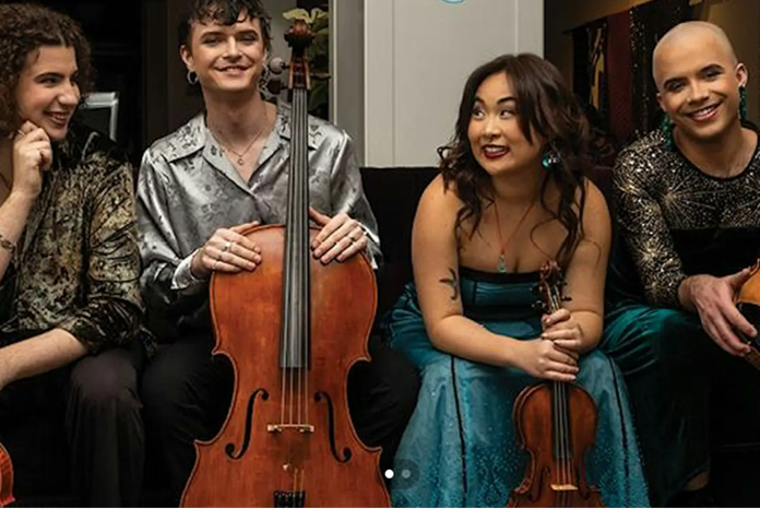 Four members of Poiesis Quartet sit together with string instruments, including a cello, violin and viola.