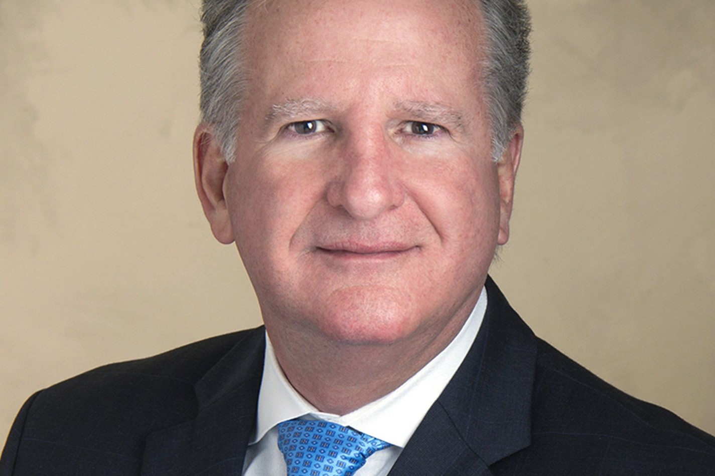 Formal headshot of Coral Gables City Manager Peter Iglesias wearing a dark suit and blue tie.