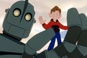 Animated scene from The Iron Giant showing a young boy standing in the hand of a large robot.
