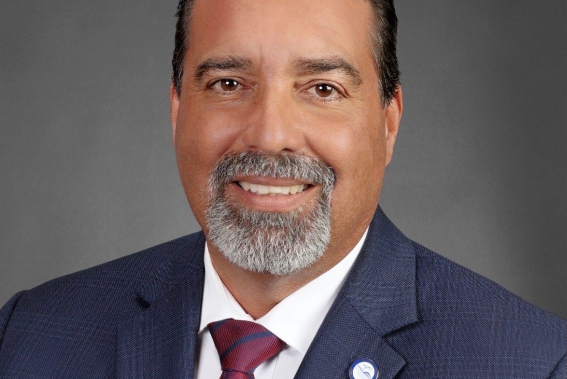 Headshot of Rafael Villalobos, incoming superintendent of Miami-Dade County Public Schools, wearing a dark suit and red tie.
