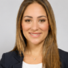 Head-and-shoulders portrait of Coral Gables Commissioner Melissa Castro wearing a dark blazer against a light gray background.