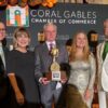 Codina receives Coral Gables Chamber’s highest individual honor From left, Jorge Martinez, Gloria V. Baez, Armando Codina holding the George E. Merrick Award, Maria Garcia and W. Allen Morris pose in front of a Coral Gables Chamber of Commerce backdrop.
