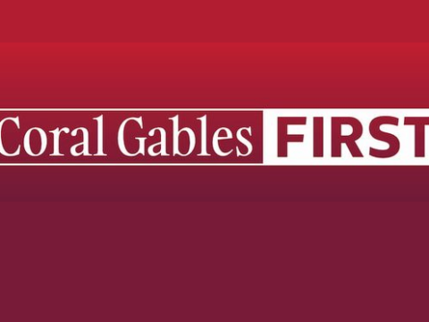Coral Gables First logo in white lettering on a red and burgundy background.