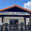 Exterior of Havana Harry’s restaurant in Coral Gables, with its large sign above the entrance under a red-tile roof.