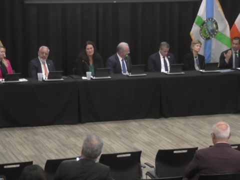 Seven Coral Gables and Miami-Dade officials sit at a long panel table during Mayor Vince Lago’s Sept. 23 Town Hall at the Public Safety Building.