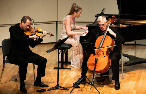 Scott Flavin plays violin, Lindsay Garritson plays piano and Ross Harbaugh plays cello during a Bergonzi Piano Trio performance.