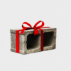 A gray concrete block wrapped like a gift with a bright red ribbon and bow against a white background.