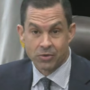 Coral Gables Mayor Vince Lago wearing a dark suit, blue checked shirt and patterned tie.