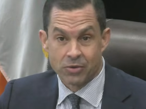 Coral Gables Mayor Vince Lago wearing a dark suit, blue checked shirt and patterned tie.