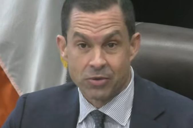 Coral Gables Mayor Vince Lago wearing a dark suit, blue checked shirt and patterned tie.