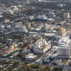 Aerial photograph of Coral Gables' North Ponce area, showing mid-rise and high-rise buildings, intersecting streets and tree-lined residential neighborhoods.