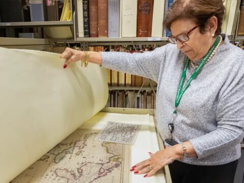 Gladys Gómez-Rossié looks through archival maps in the Cuban Heritage Collection. (Photo: Joshua Prezant/University of Miami)